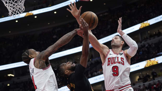 Chicago Bulls forward DeMar DeRozan (11) center Nikola Vucevic (9) defend Cleveland Cavaliers guard Darius Garland (10) during the second half at United Center.